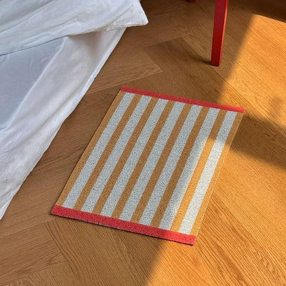 High angle view of Mustard Yellow Striped PVC Coil Rug in bedroom - RoomDen