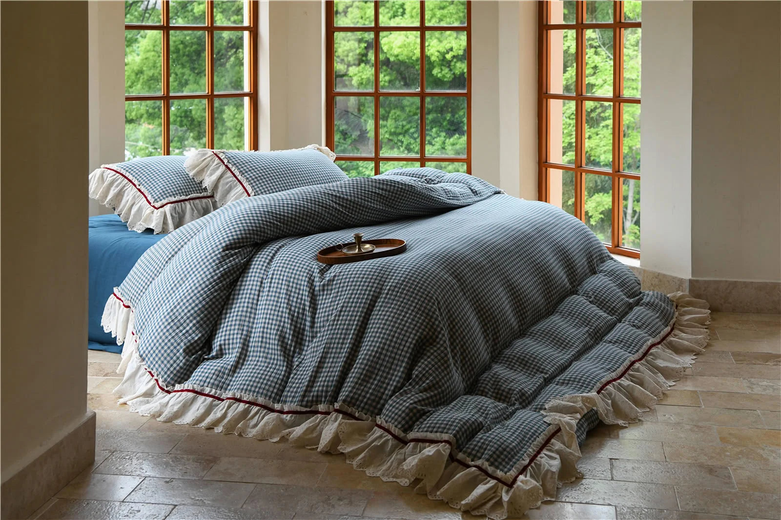 Angled view of the Blue Gingham Bedding Set, showing the texture of the ruffles and duvet cover.