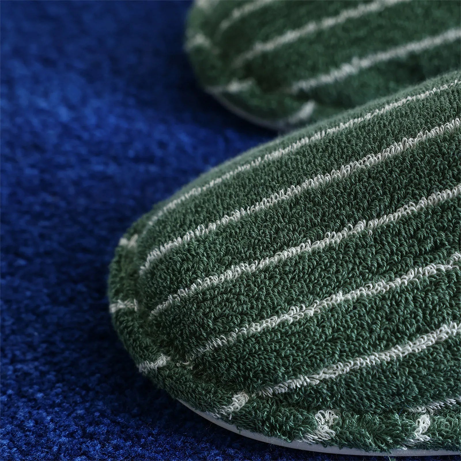 Close up detail of green terry cloth texture with white pinstripes