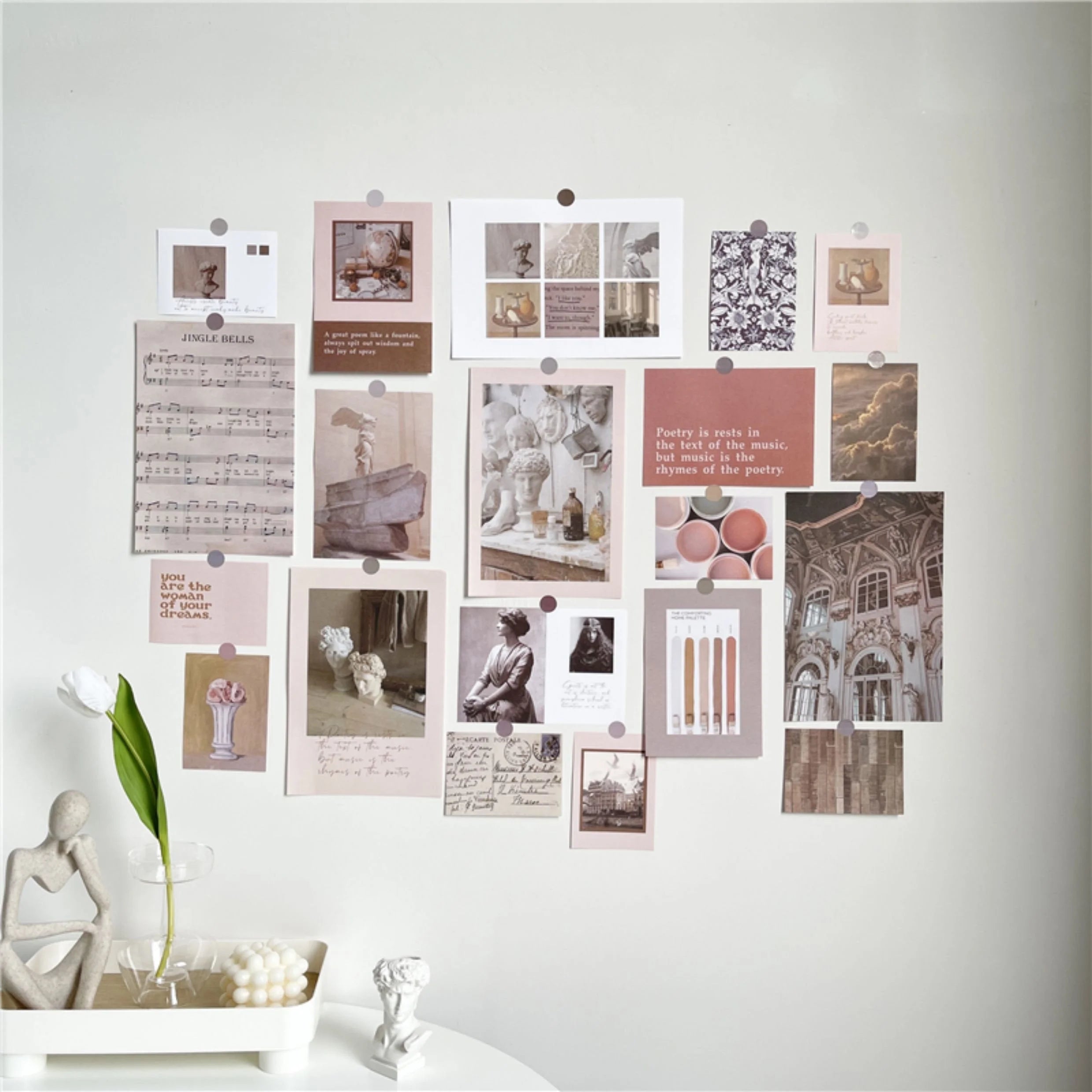 A slightly wider shot of the Light Academia collage kit on the wall, showing a white tulip in a vase - RoomDen.