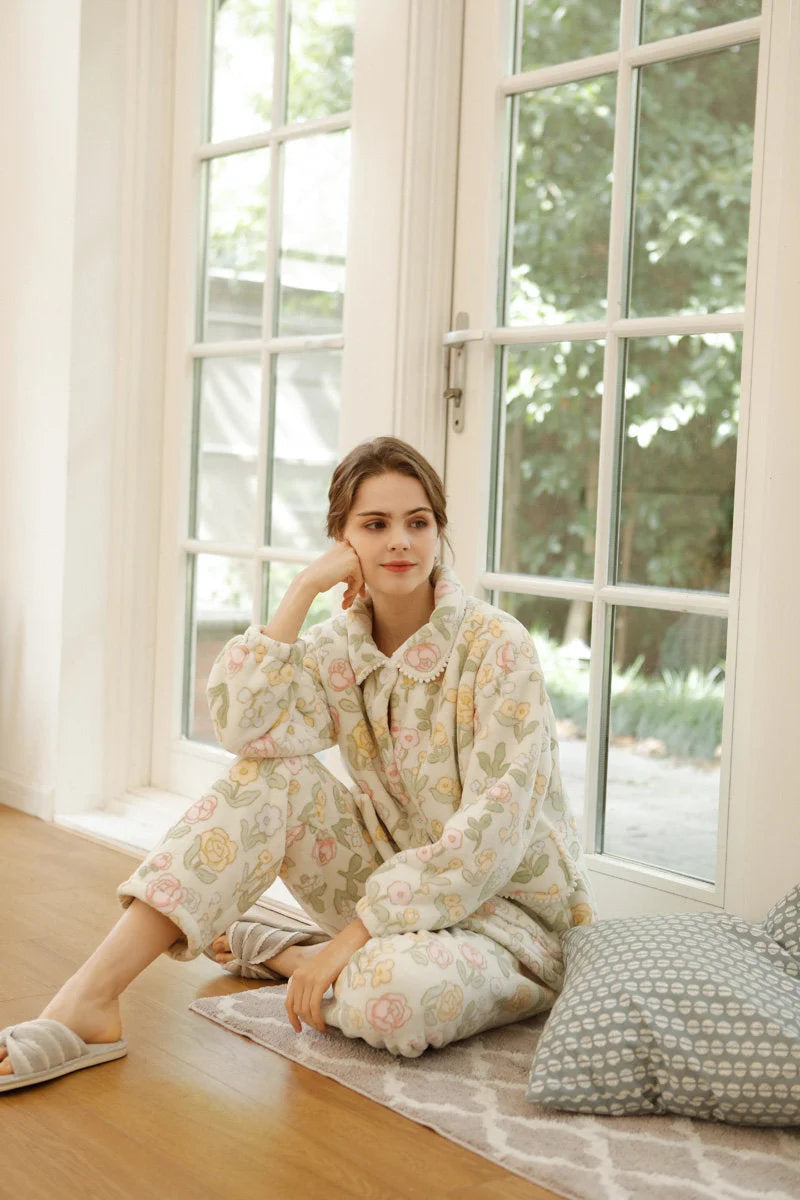 Full body shot of model sitting on floor in floral pajamas - RoomDen