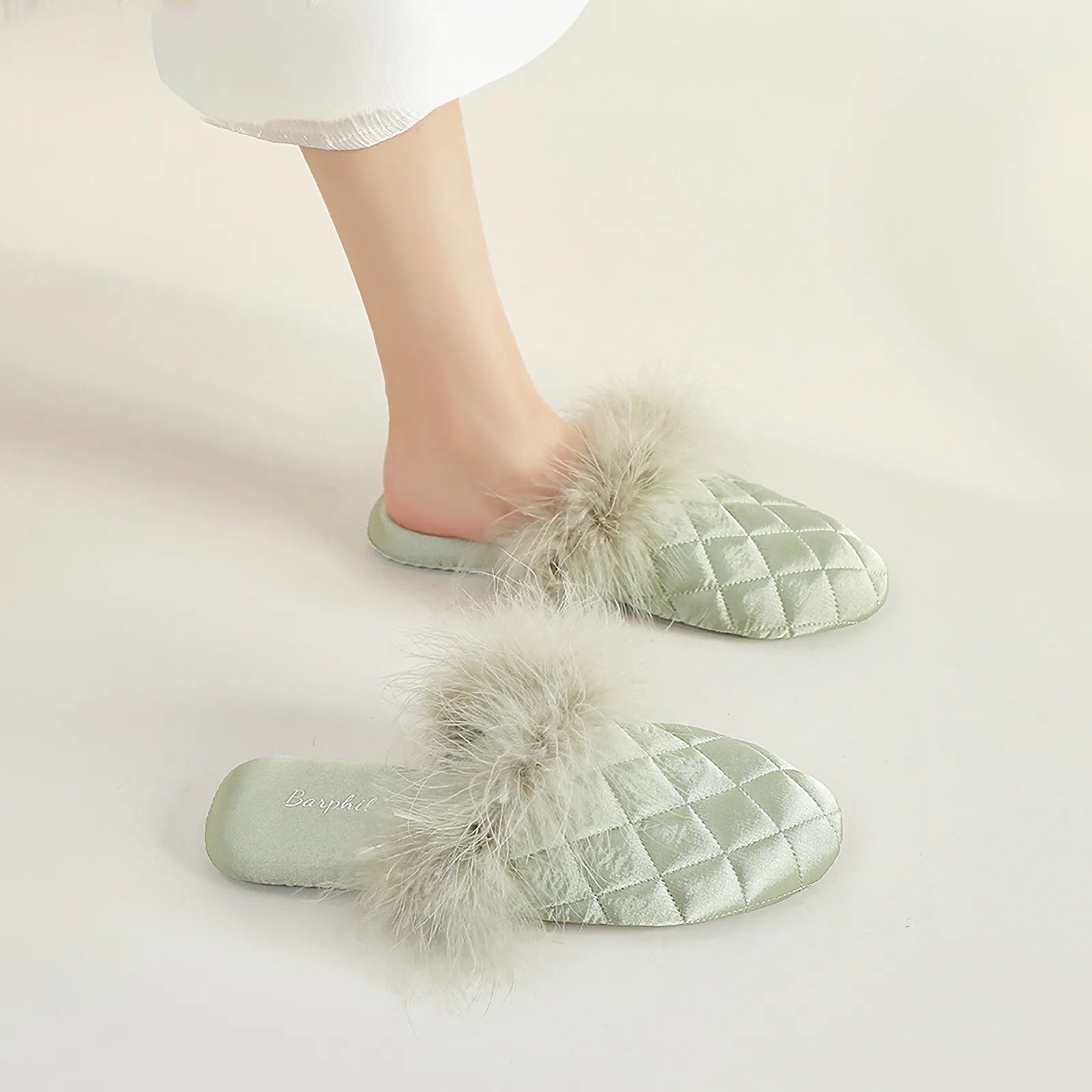 Side profile of sage green satin slippers showing sole thickness