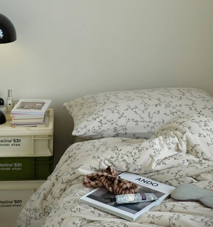 A styled bedroom scene featuring the Soft Dainty Vine Washed Cotton Bedding Set on a bed next to a crate nightstand. - RoomDen