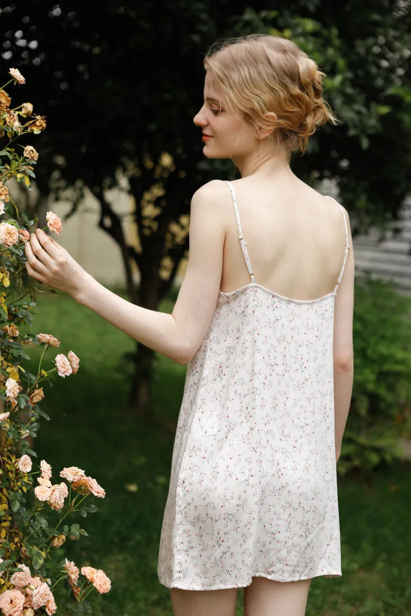Back view of white floral slip dress showing spaghetti straps detail