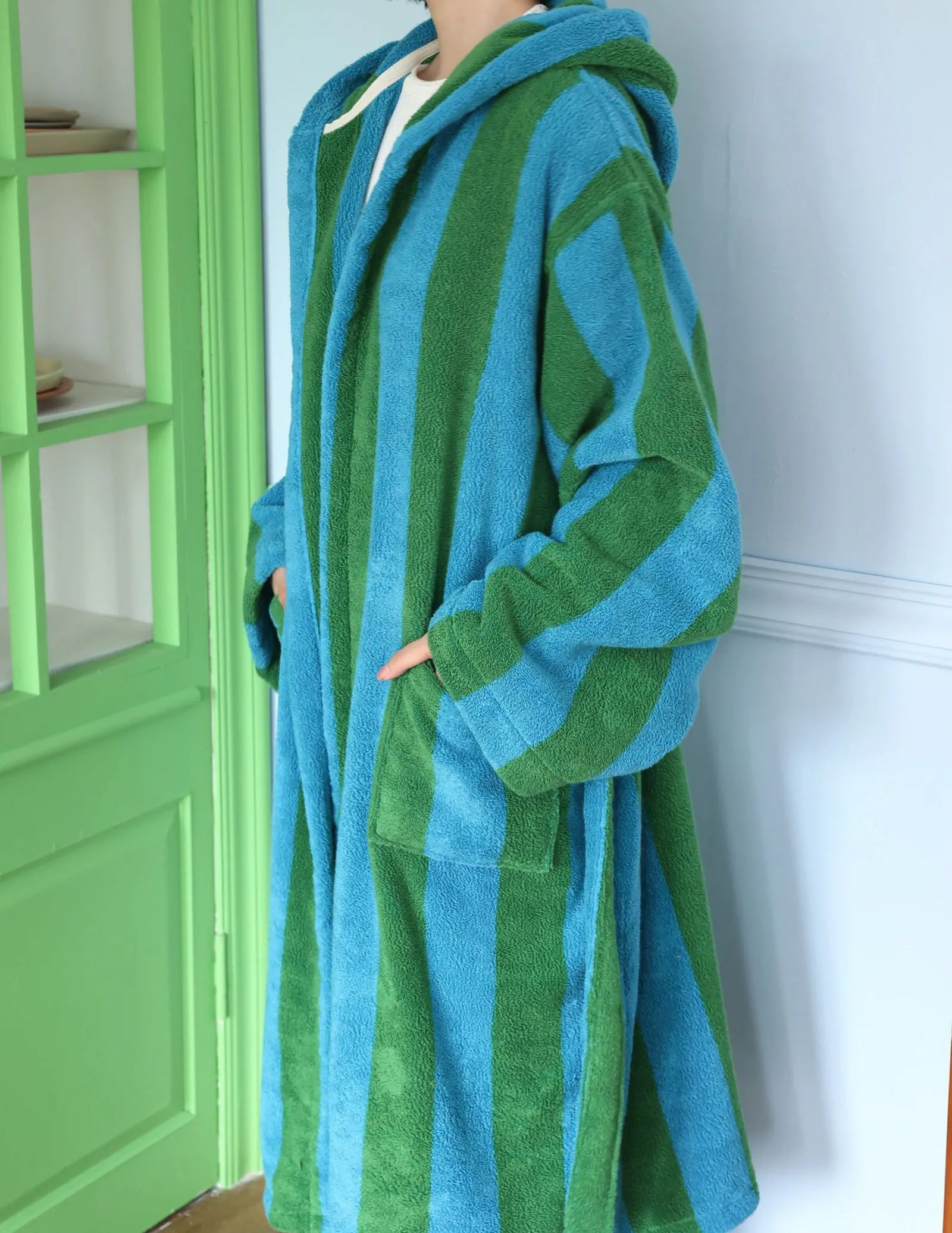 Woman adjusting the hood of the soft cotton terry robe, indie aesthetic style - RoomDen