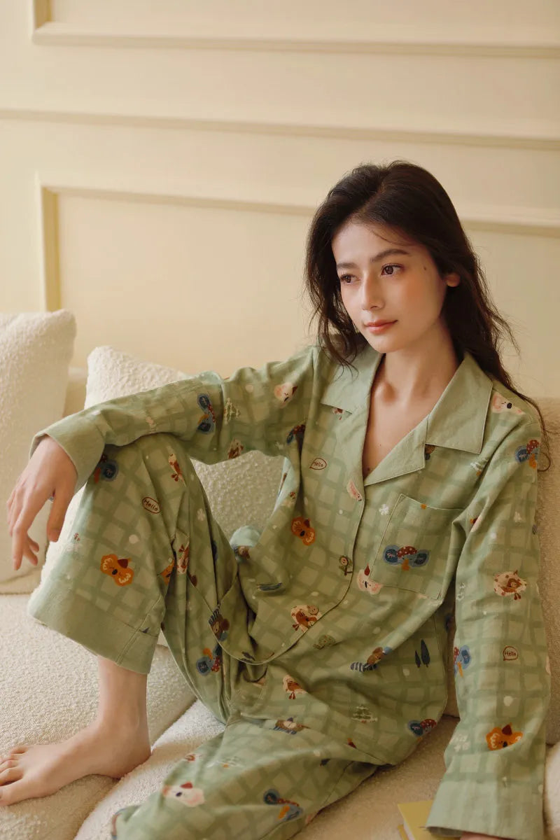 RoomDen Soft Koala Plaid Washed Cotton Pajama - Main view of woman sitting on sofa wearing sage green set