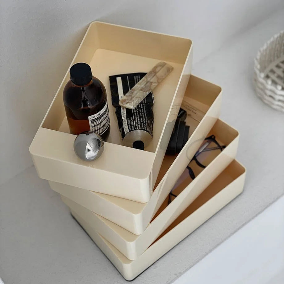 Top-down view of the Cream Beige makeup organizer's tiers holding skincare products. - RoomDen
