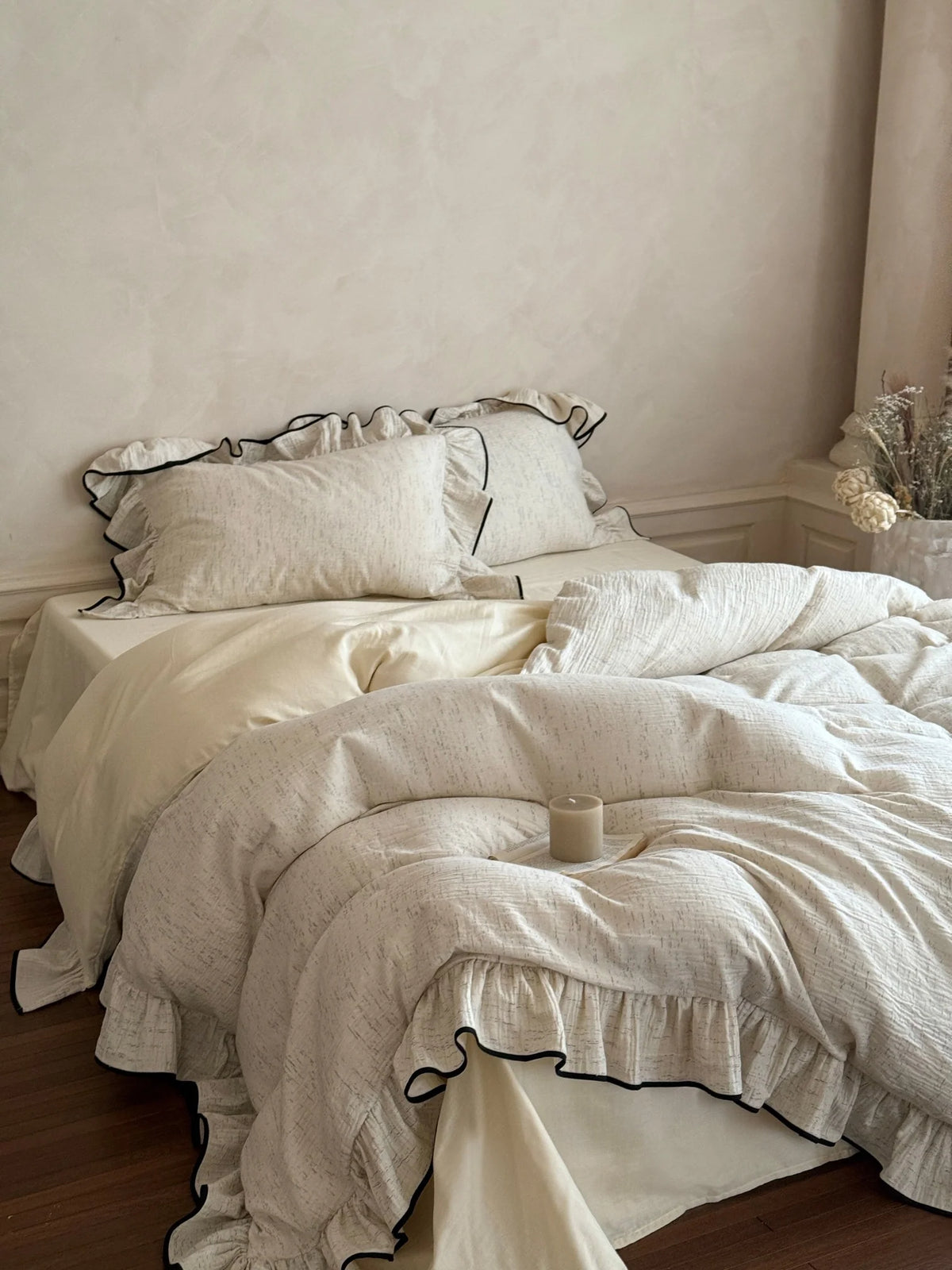 Black-piped ruffle double gauze bedding set – full Oat Heather bed in a warm neutral room - Roomden