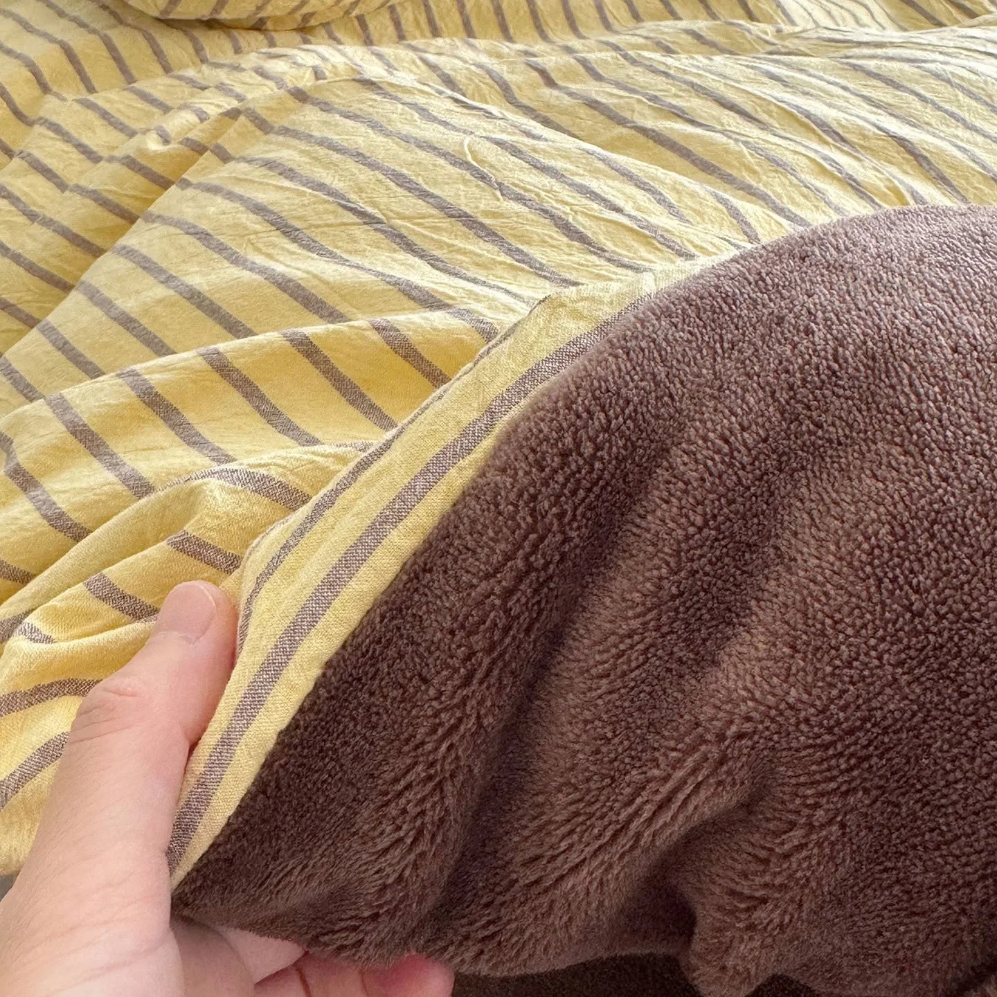 Close-up showing the warm, fuzzy texture of the brown flannel fleece side of the duvet cover.