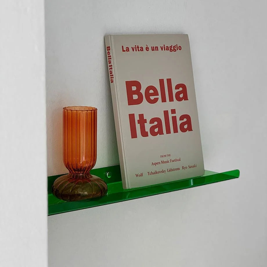 Angled view of the green acrylic shelf, highlighting its translucent quality and minimalist design.