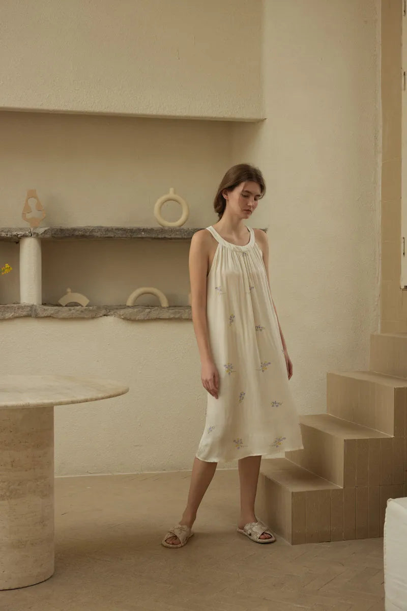 Woman wearing vintage style floral sleep dress in rustic cottagecore room - RoomDen