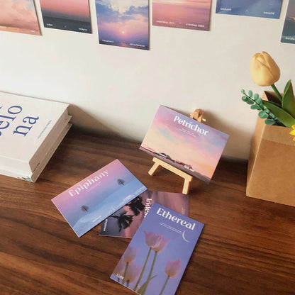 Close-up of the Dreamy Landscape & Word Art cards from the wall collage kit on a desk - RoomDen