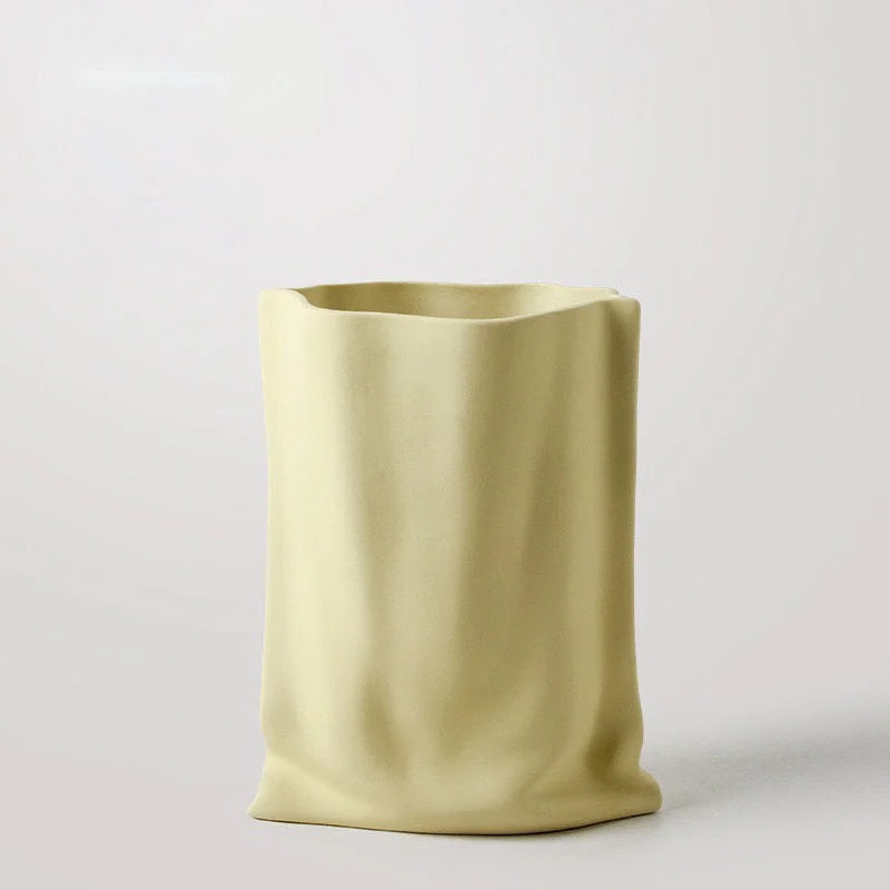 The Frosted Ruched Ceramic Paper Bag Vase in a delicate Buttercream Yellow shade - RoomDen.