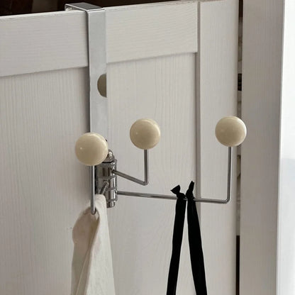 Angled view of the beige door hook, highlighting its clean lines and minimalist aesthetic - RoomDen