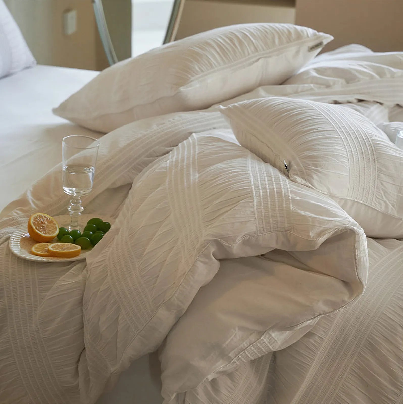 Close-up on the fluffy, textured layers of the Classic White pintuck duvet cover.