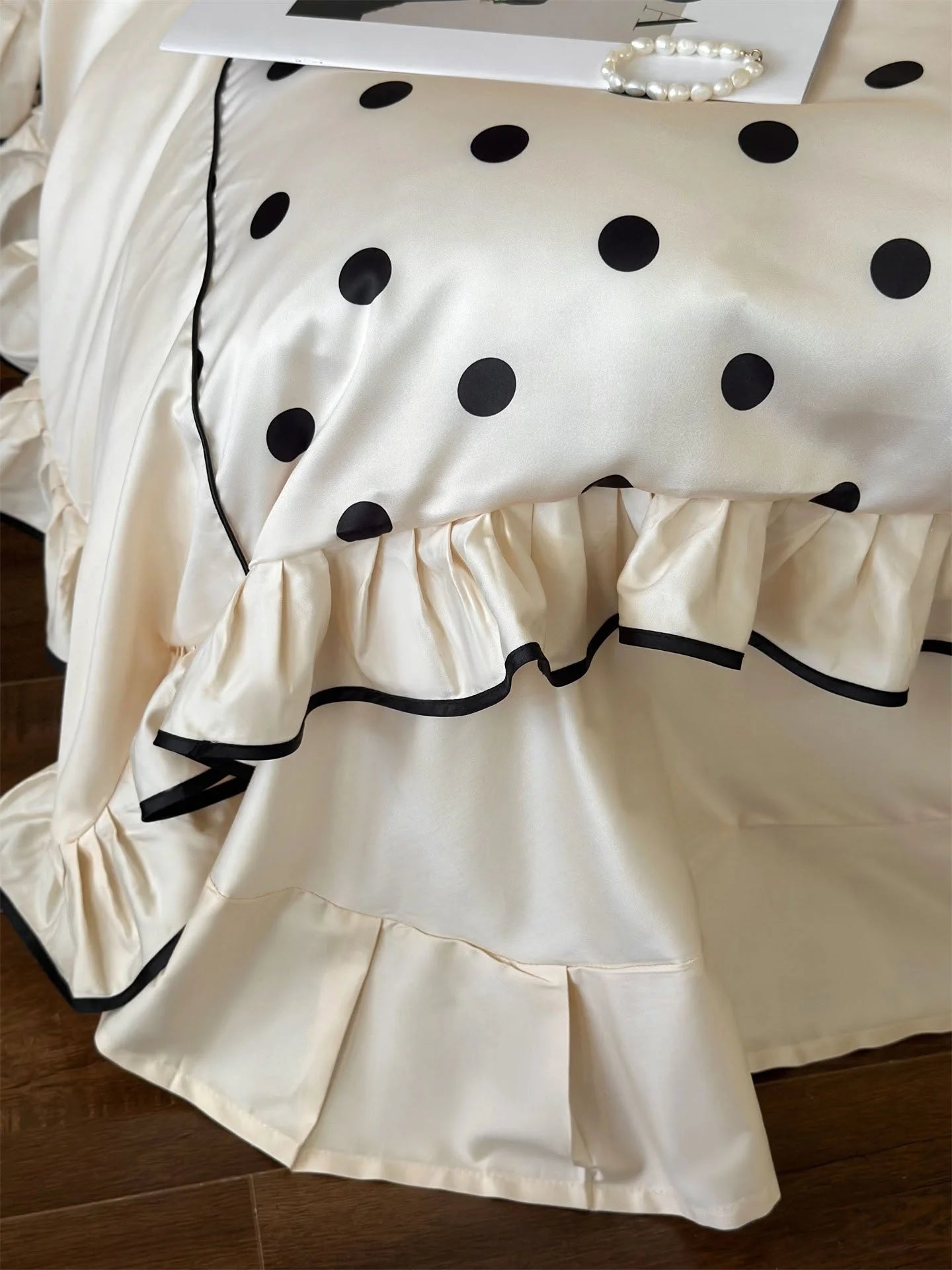 Close-up detail of the black-trimmed ruffles on the Creamy White & Black Polka Dot bed skirt - RoomDen.
