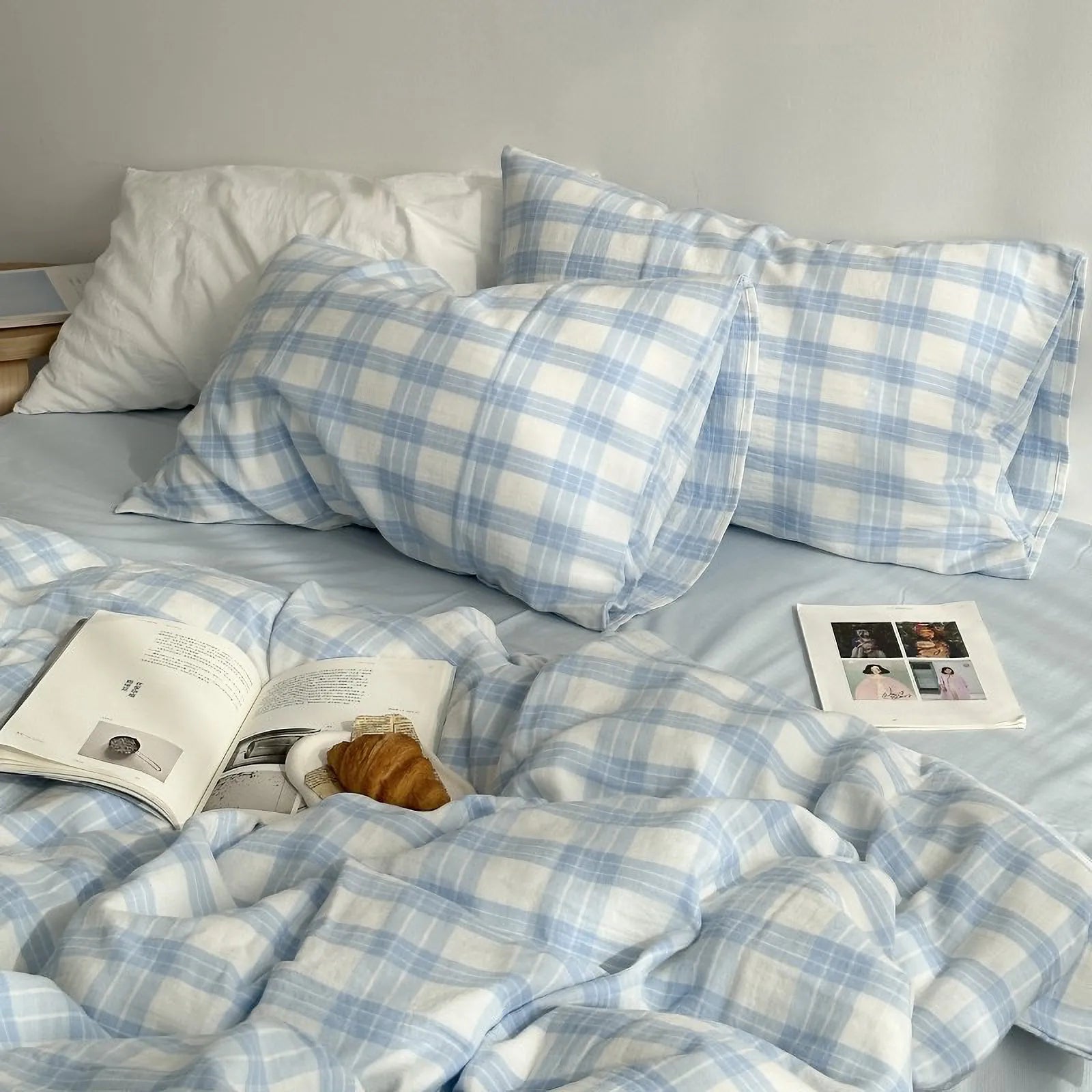 Angled view of the sky blue gingham plaid bedding, showcasing the duvet cover and matching pillowcases on a neatly made bed.