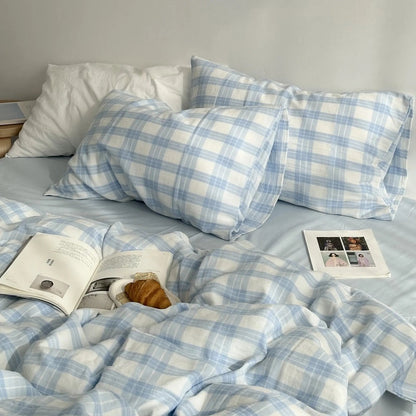 Angled view of the sky blue gingham plaid bedding, showcasing the duvet cover and matching pillowcases on a neatly made bed.