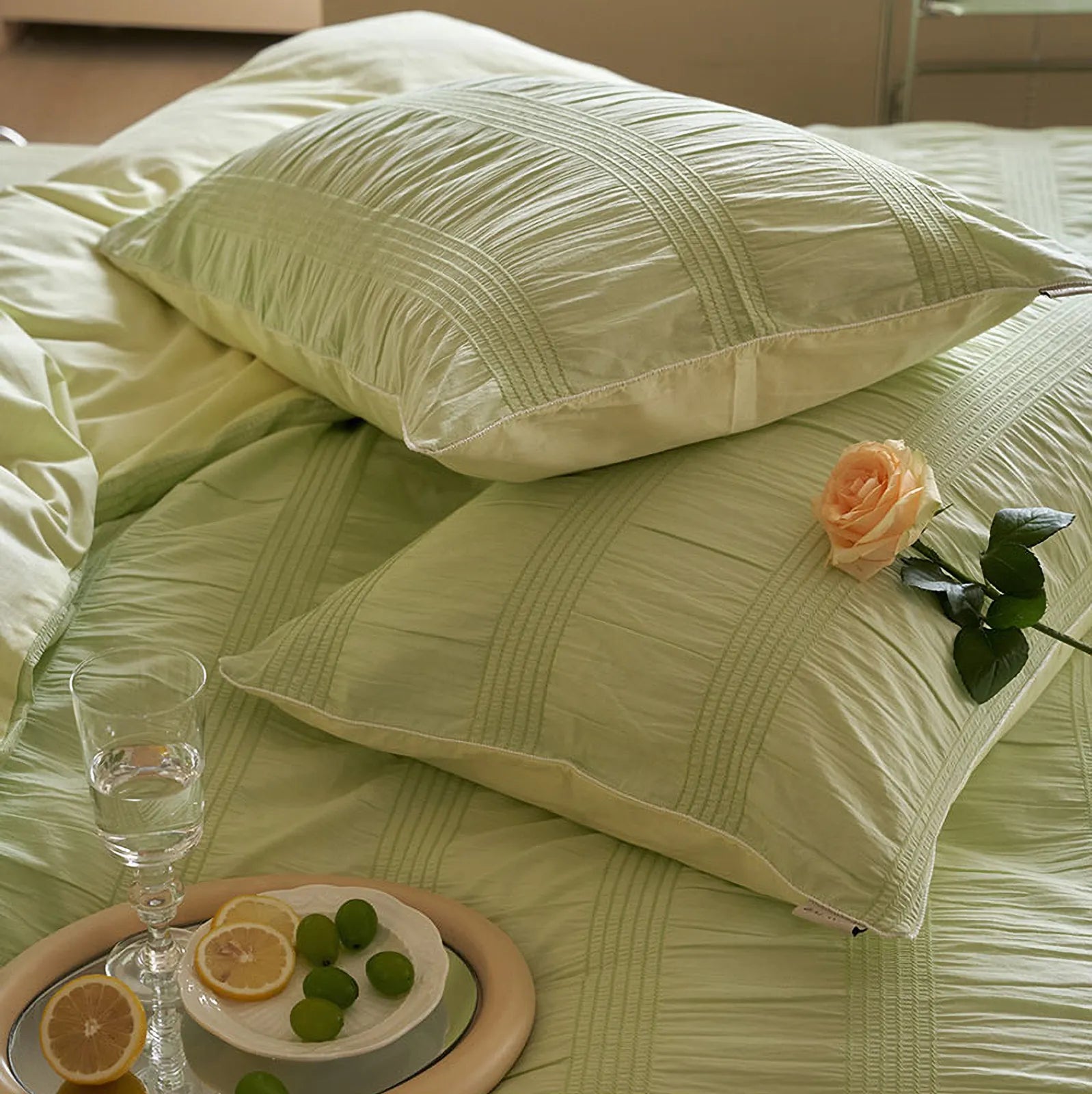 Detailed shot of two Pistachio Green pillowcases showing the pintuck stripe design.