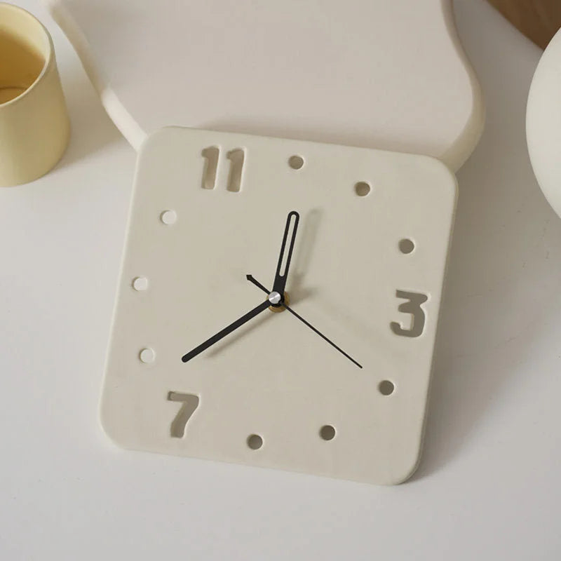 Top view of the Cream Minimalist Cutout Ceramic Table Clock next to a yellow cup - RoomDen.