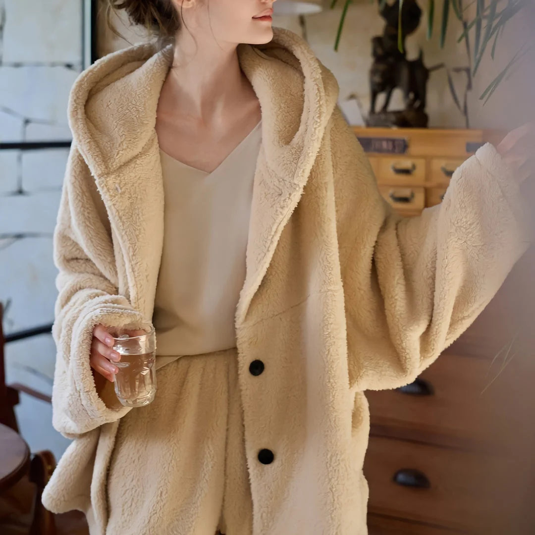 Close-up of the plush texture and hood of the beige flannel fleece pajama top. - RoomDen