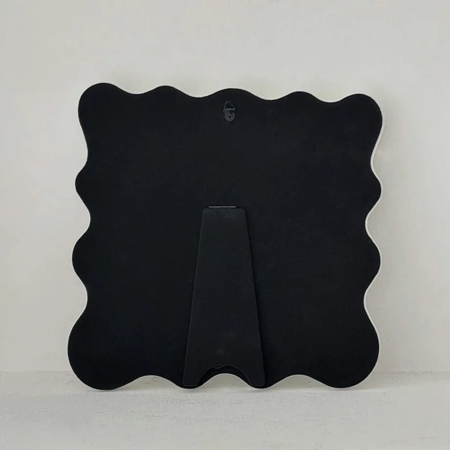 Full view of the back of the mirror, showing both the wall hook and the pop-out stand - RoomDen