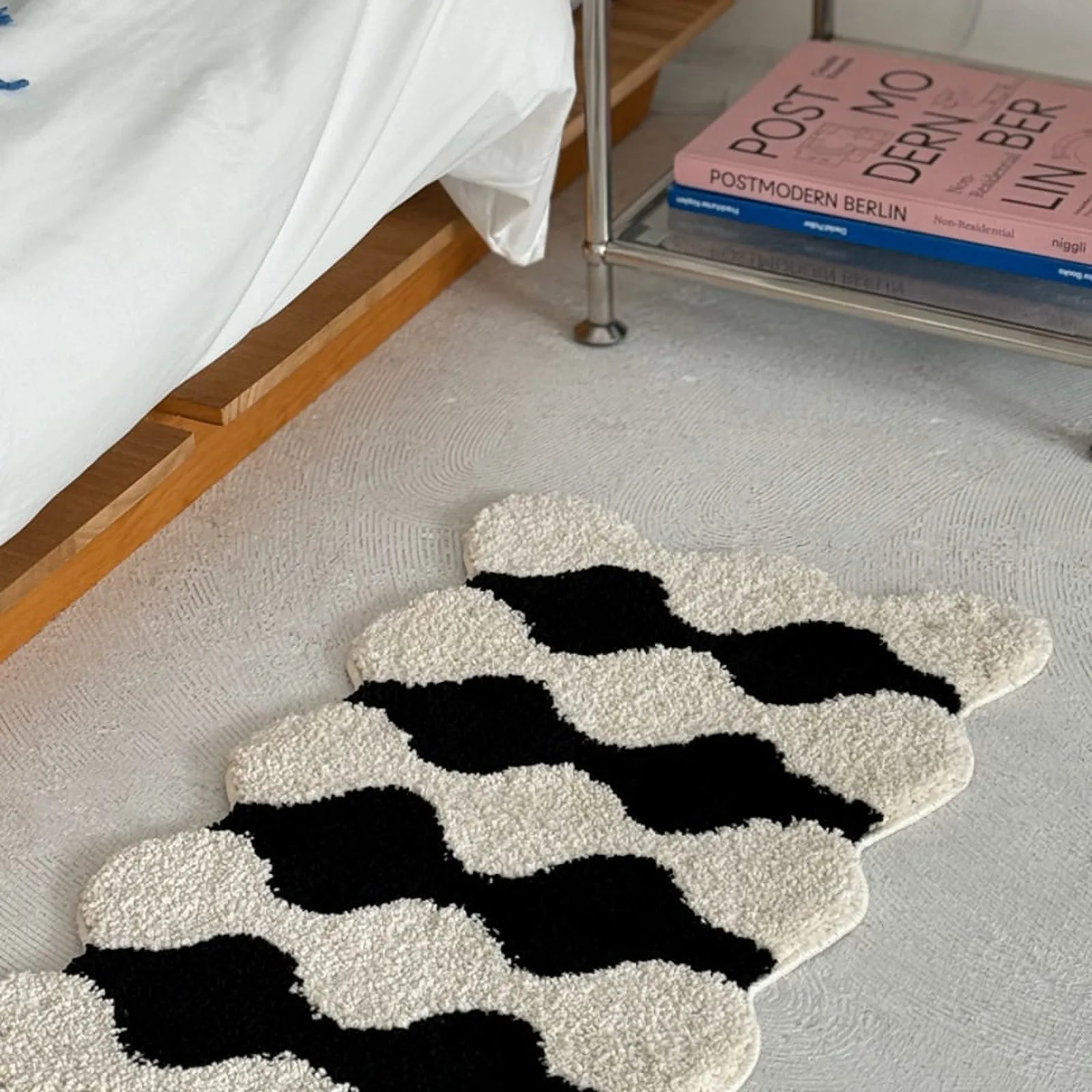 Perspective shot of wavy rug texture near bed frame - RoomDen