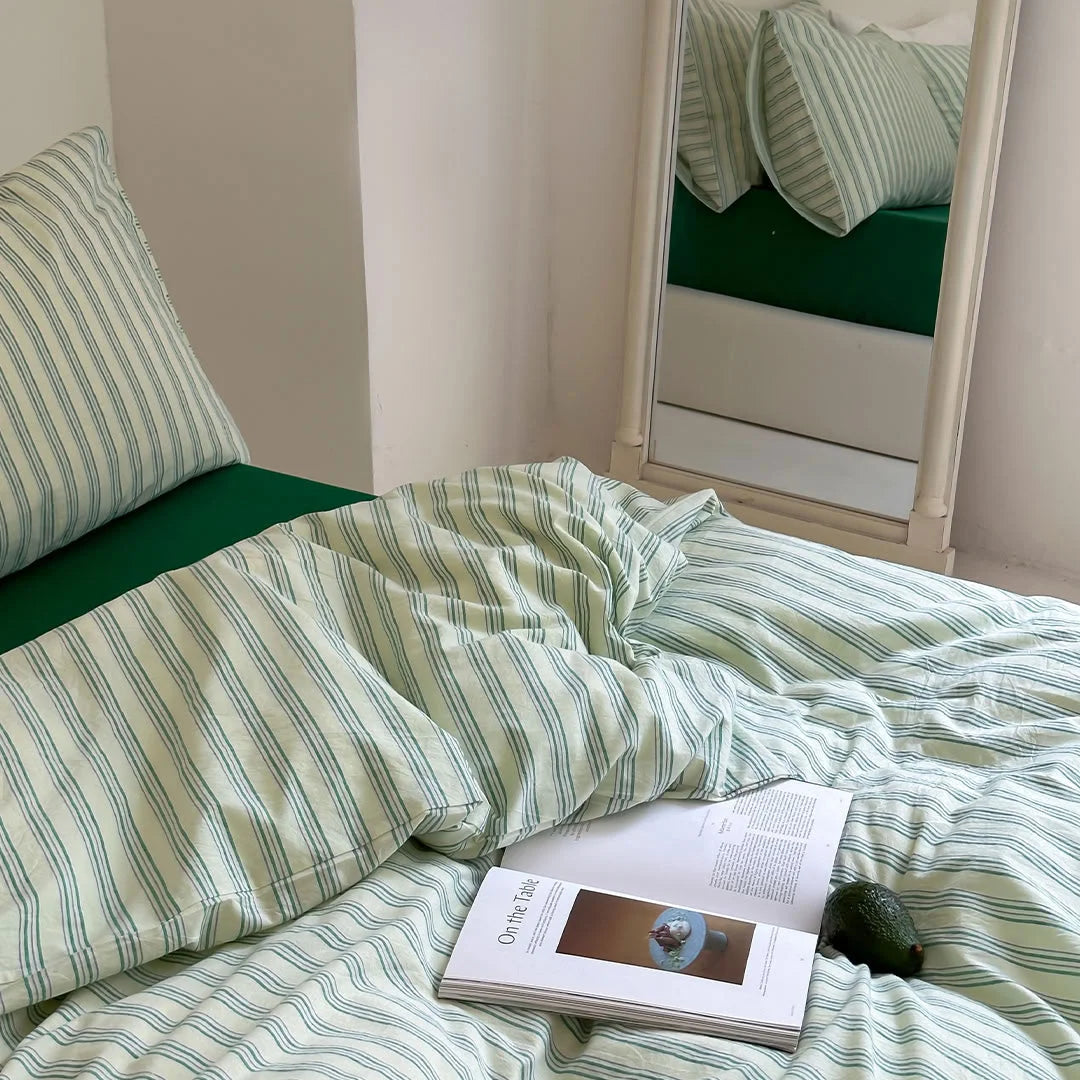 Green Striped Bedding Set High Angle View with Magazine and Avocado - RoomDen