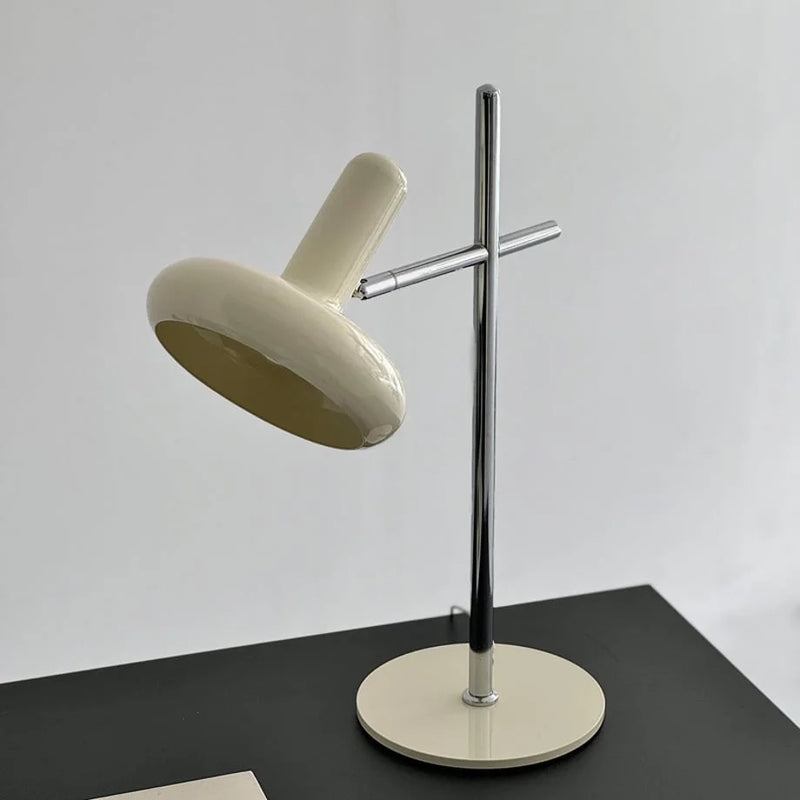 Close-up of the adjustable joint and chrome stem of the cream metal accent lamp — RoomDen