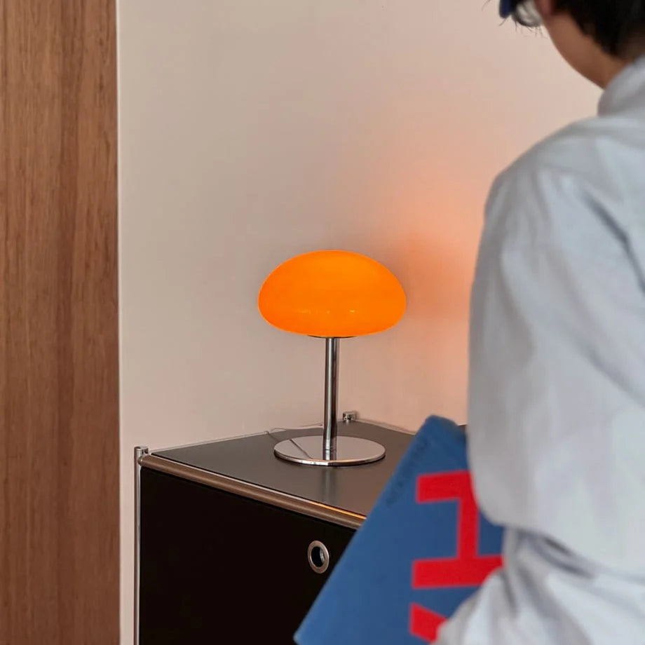 Close-up of the orange mushroom accent lamp on a black console table - RoomDen.