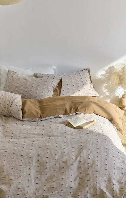 Overhead view of the Textured Ditsy Cherry Plaid Washed Cotton Bedding Set, highlighting the pattern and reversible design.