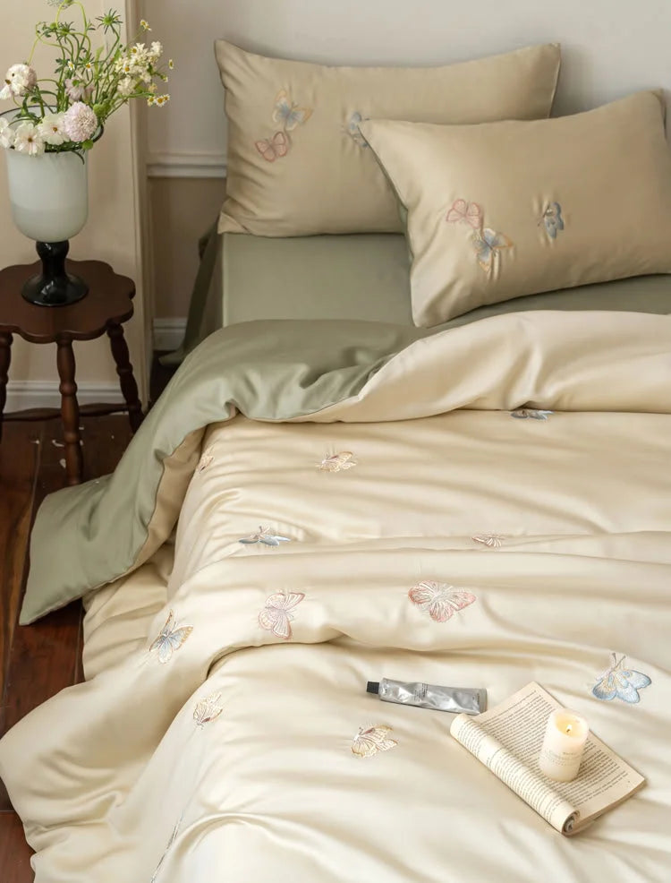 Close-up of the silky Tencel fabric and delicate butterfly embroidery on the duvet cover and pillows - RoomDen