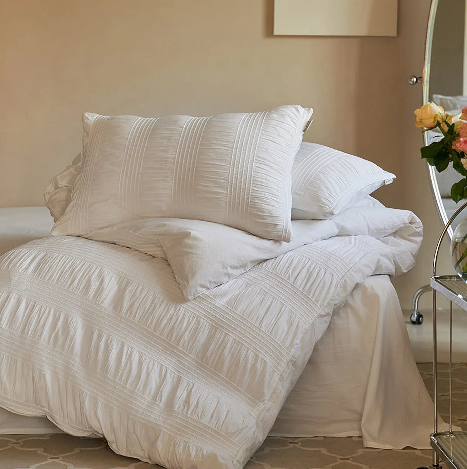 Textured Pintuck Washed Cotton Bedding Set in Classic White on a bed against a beige wall. - RoomDen