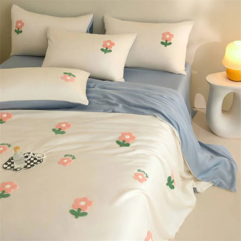 Tufted Doodle Flower bedding in White & Sky Blue with a decorative tray on top. - RoomDen