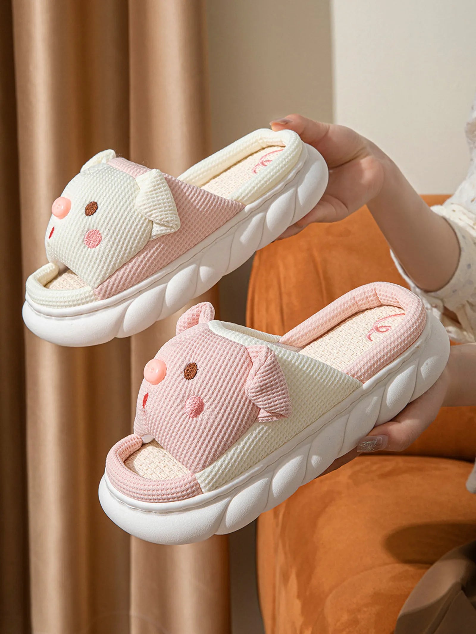 Hand holding White and Pink Waffle Textured Embroidered Pig Linen House Slippers showing waffle texture - RoomDen
