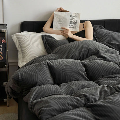 Woman holding a book in bed, wrapped in the plush Charcoal Grey Wavy Arch Flannel Fleece Bedding Set. - RoomDen