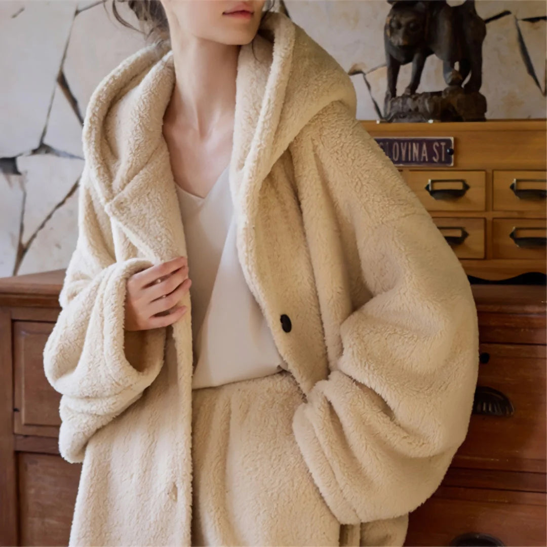 Detail shot of the soft flannel fleece fabric and button on the beige hooded pajama top. - RoomDen