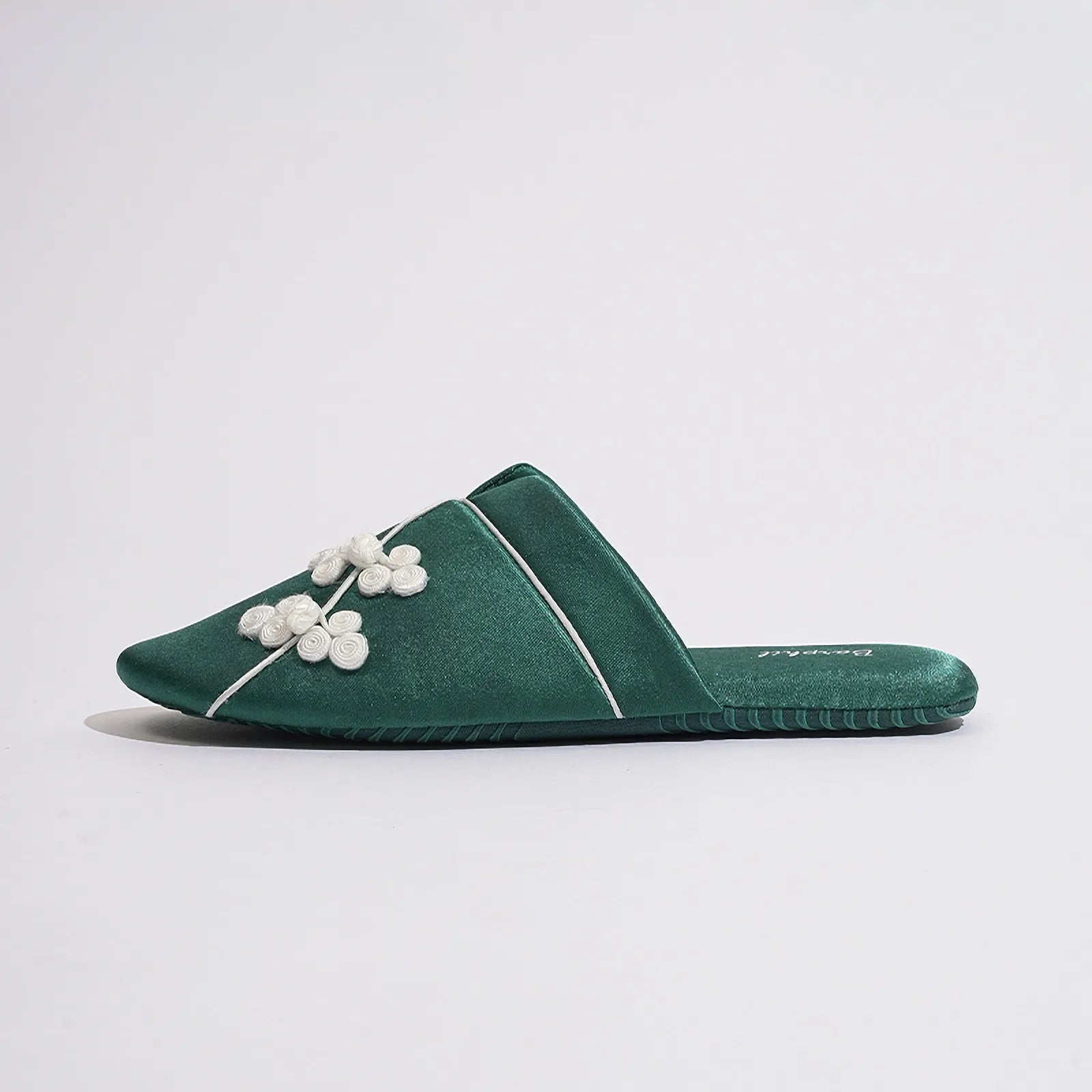 Pair of Serenity Blue slippers placed on the floor showing embroidery - RoomDen