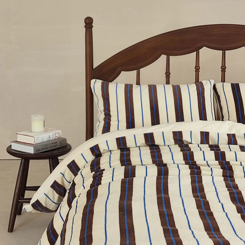 The cream and brown striped velvet bedding set styled in a Light Academia themed room - RoomDen.