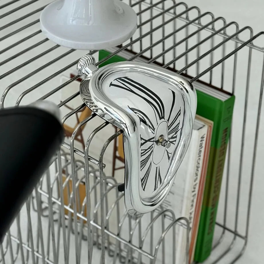 Detail shot of the silver melting clock's chrome finish and dripping design.