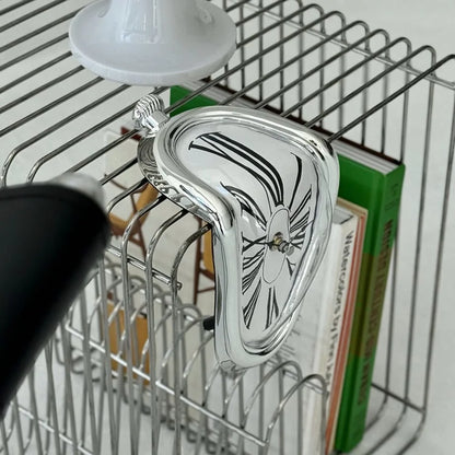Detail shot of the silver melting clock's chrome finish and dripping design.