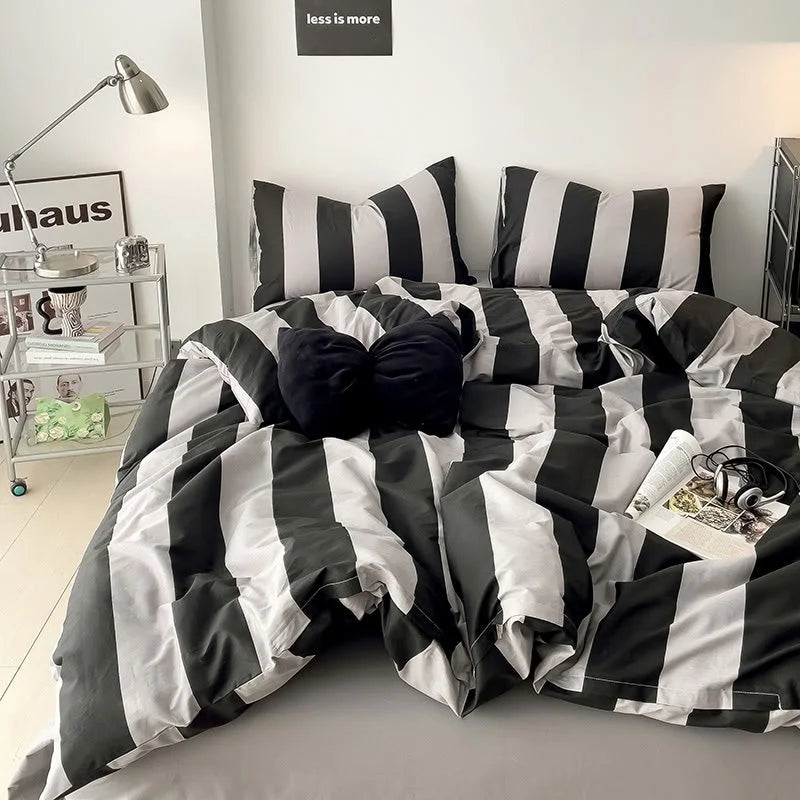 Black & Grey Bold Stripe Bedding Set styled with a black bow pillow in a modern dorm room - RoomDen