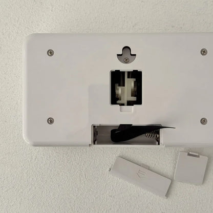 Back view of the flip clock showing the battery compartment and wall mount hole. - RoomDen