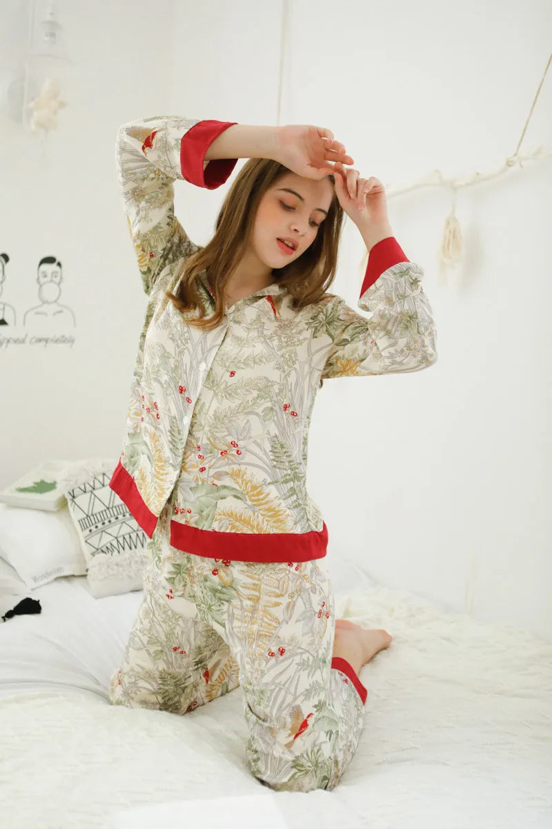 RoomDen Silky Festive Berry Botanical Cotton Sateen Pajama Set - Stretching Pose on Bed - Morning Routine