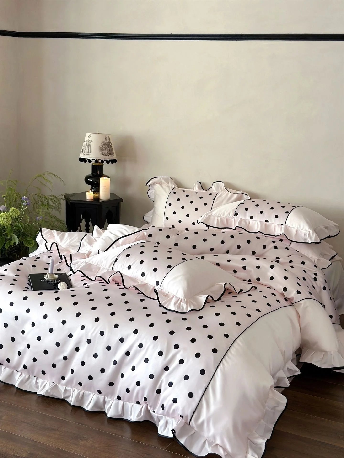 Overhead view of the Blush Pink & Black Polka Dot Bedding Set, styled with a book on the bed - RoomDen.