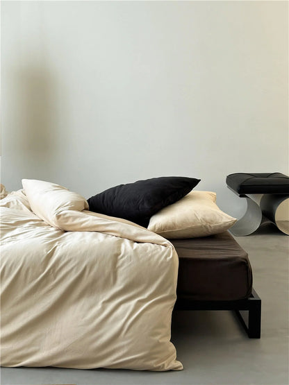 Side angle of a bed with a Warm Beige velvet duvet cover on a Mocha Brown sheet in a bright, airy room. - RoomDen