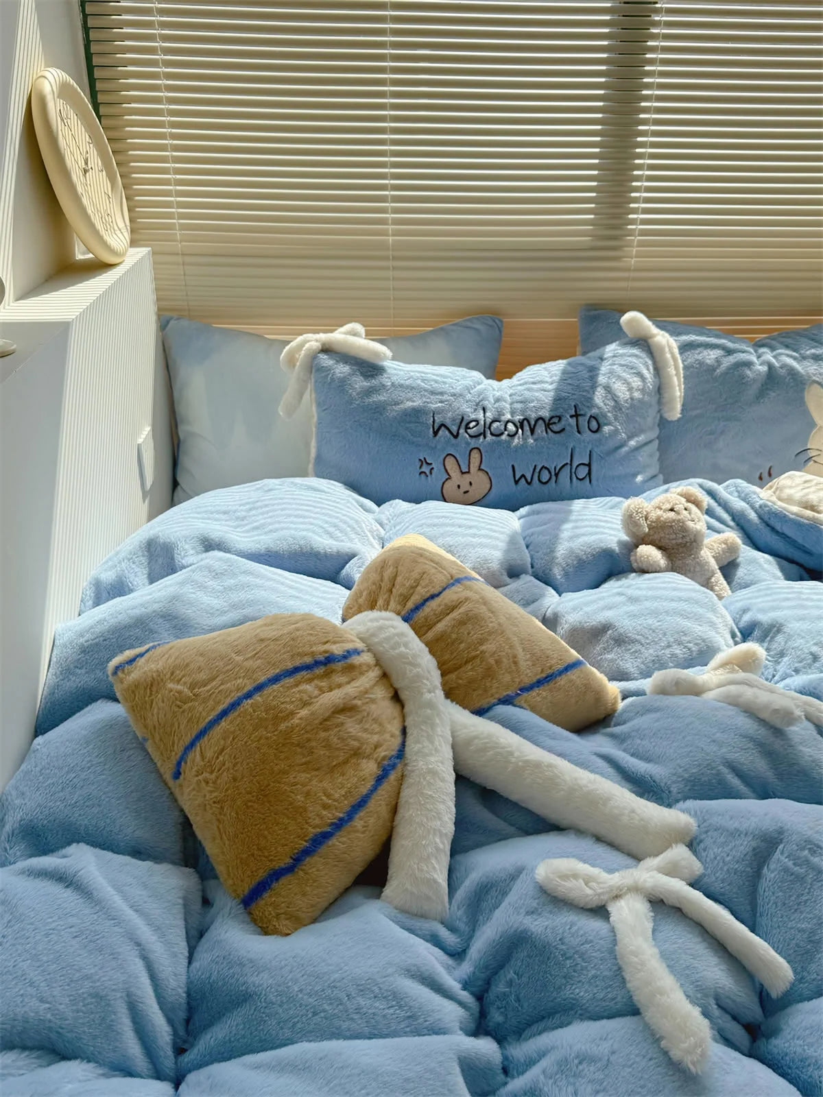 Another lifestyle shot of the Baby Blue Bunny bedding with different decorative pillows. - RoomDen