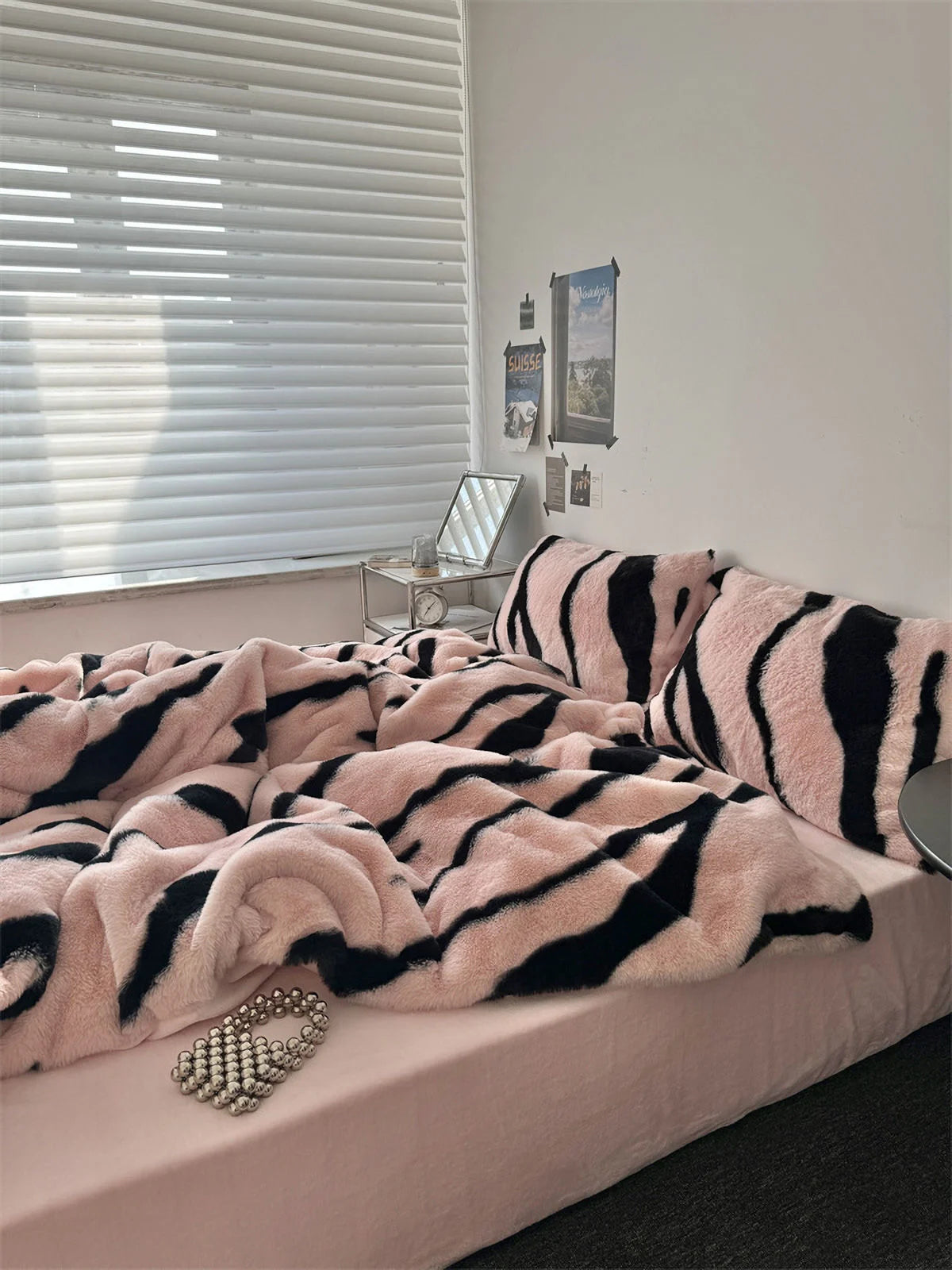 A closer look at the Blush Pink and Black Tiger Stripe duvet cover, showing the soft flannel fleece texture and pearl necklace accent. - RoomDen