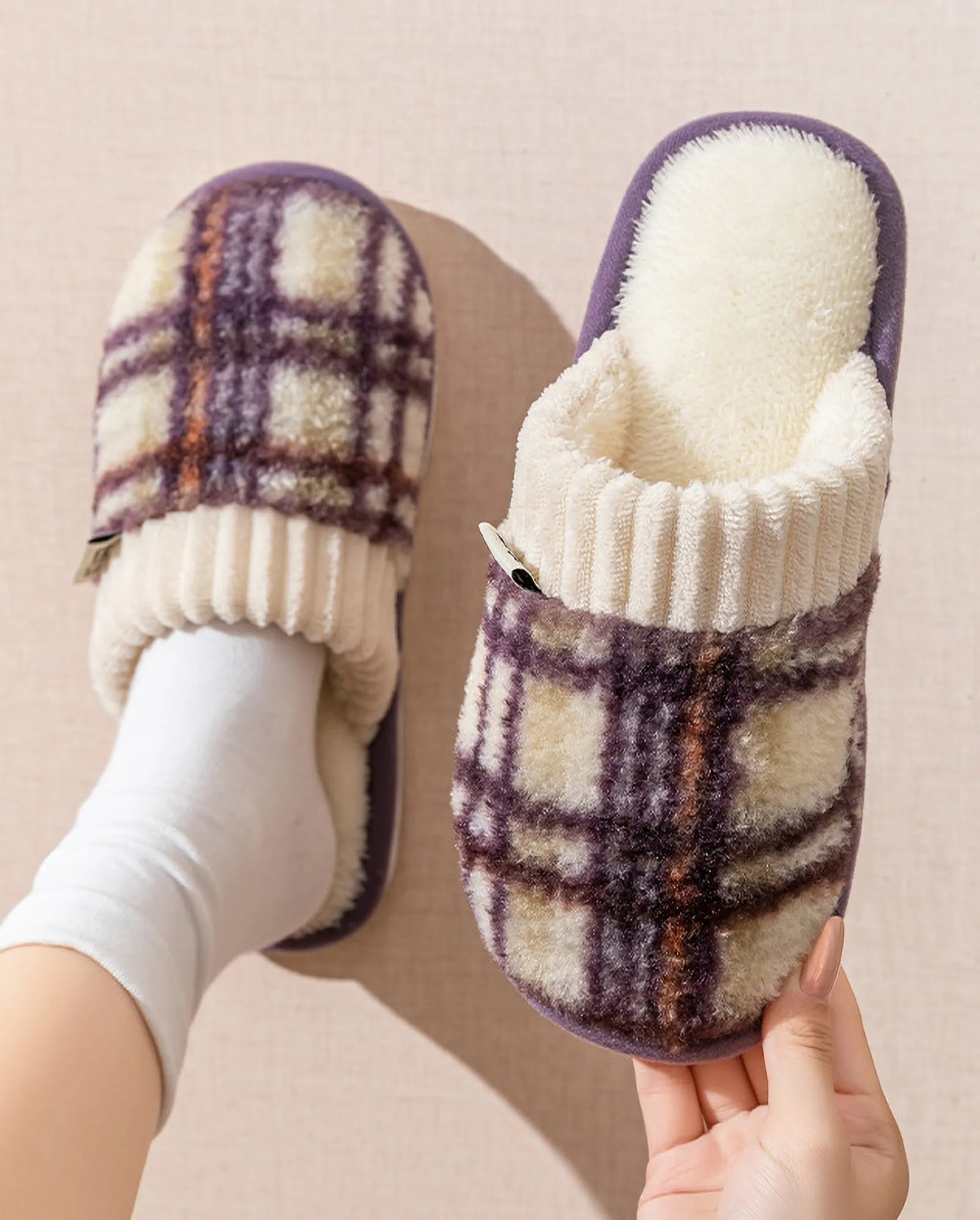 Model wearing purple and cream plaid fuzzy house slippers with white socks - RoomDen
