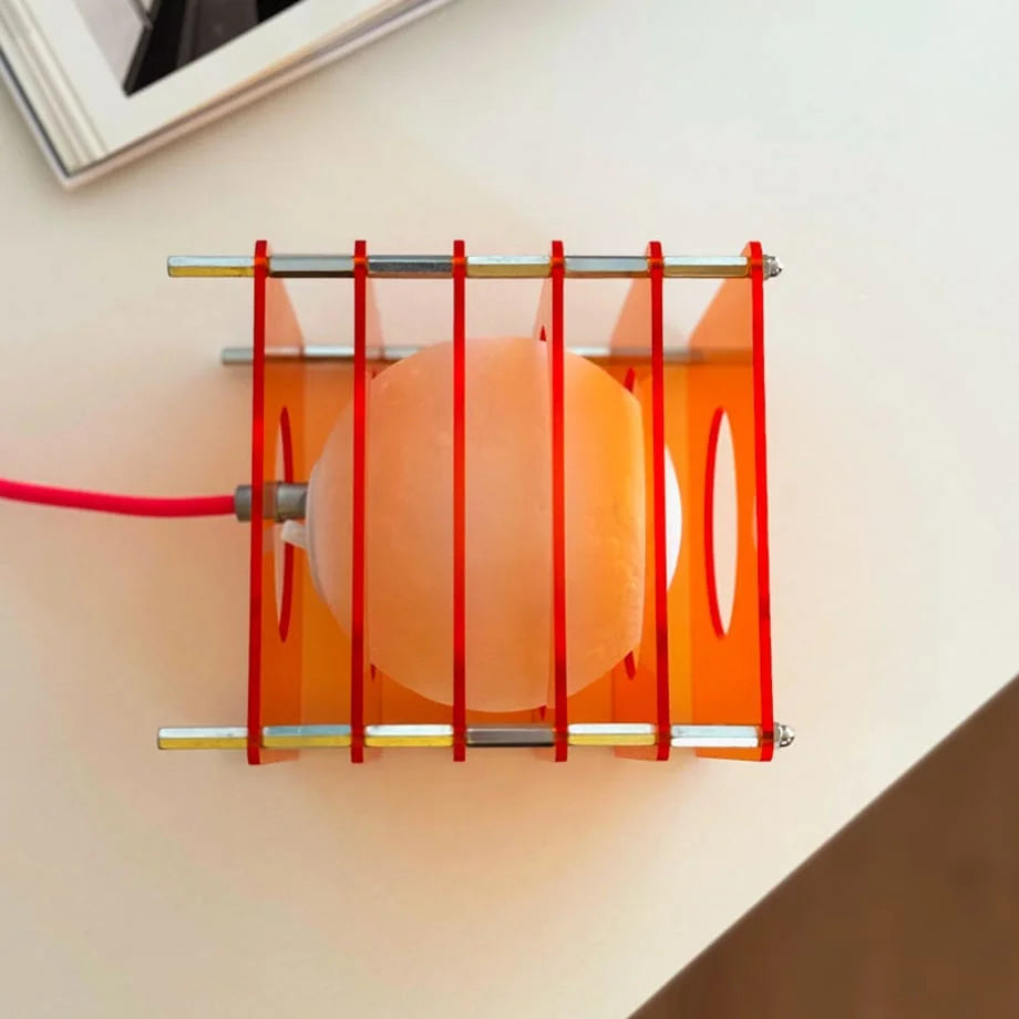 Top-down view of the Sunset Orange Caged Sphere Lamp, showing the inner orb and red elastic bands - RoomDen